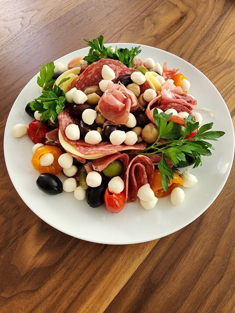 Antipasto salad with tomato, olives, mozzarella, and basil