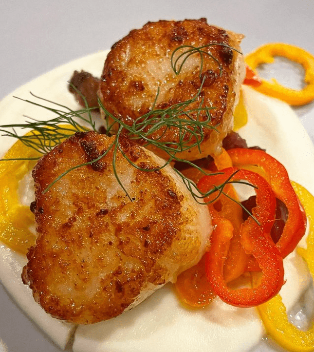 An entree of Seared Scallops on Celery Root Puree topped with Mini Pickled Pepper Rings as prepared by Chef Marissa Finch of Honest to Goodness Personal Chef Services in Auburn, WA