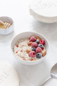 oatmeal with strawberries in white ceramic bowl