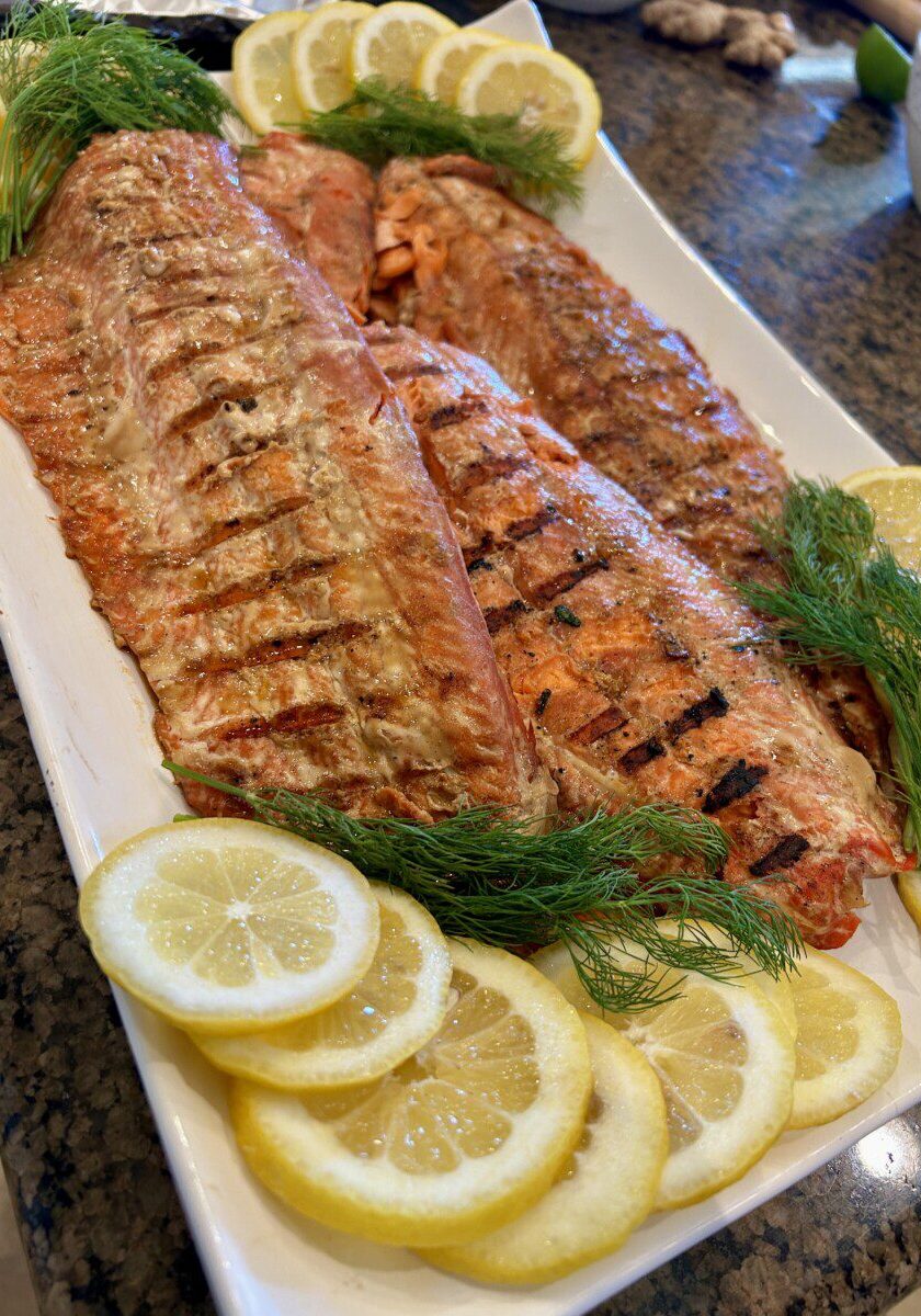 a platter with sides of grilled sockeye salmon with a ginger teriyaki glaze
