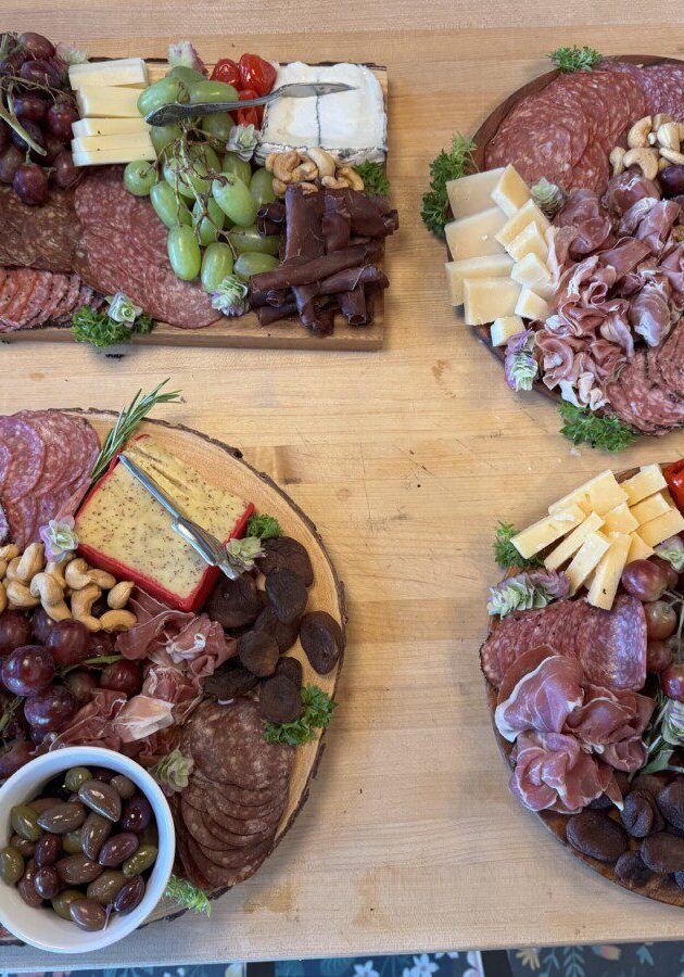 a countertop display with multiple charcuterie boards assembled for a wedding dinner
