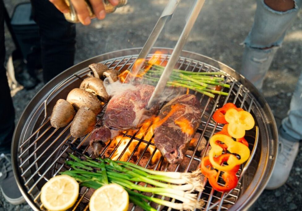 a person is cooking food on a grill