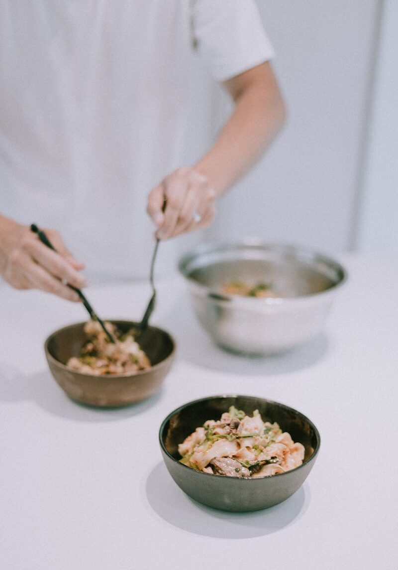 person holding spoon with rice